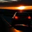 Placeholder: dark night, car taillights, driving towards a rising sun in the distance