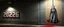 Placeholder: background of firing squad execution wall(wet textured concrete, gray, old, cracked, billet holes, blood stained, 1 wall light) from underground parking, german style, a large blocky upside down "2026" painted on left(old faded paint, red stains running down and past), cyberpunk, to the right a larger mural of a handmaid hung by a noose, Republic of Gilead