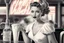 Placeholder: 50-v5.2 prompt 26: Using the Grisaille technique, create a vintage Pin-up Girl in a classic 1950's diner setting. elegantly sipping a milkshake with an iconic jukebox in the background. -ar 16:9 -s 50. -v