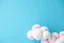 Placeholder: sky blue background with stuffed toy white clouds highlighted with pinks and pastel violet