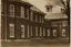 Placeholder: large estate ward many windows, distant schoolhouse at 3/4 angle, large windows, estate, realistic photograph