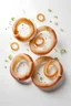 Placeholder: Fresh raw onion rings falling on white background