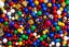 Placeholder: [dices and skulls] close-up high res photo by Barry Webb: a gypsy's wrist surrounded and saturated by strings of beads, the hundreds of beads in every color shaped like dice or skulls. It's the childlike, mortal symbol of chance intertwined with destiny.