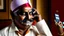 Placeholder: indian hotel keeper drools while drunk on the phone