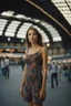 Placeholder: A realistic photo of a Milano in the main station in the background, a beautiful Italian young woman, late summer evening. Photo taken by Mamiya M645 camera with low-speed film, highly detailed, wide lens.