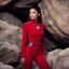 Placeholder: [sexy_in her tight red uniform, afraid and crouched] A young Star Trek ensign, donning a red uniform, experiences fear during her first away mission. Hiding beneath a large rock, she exudes a mix of curiosity and anxiety. Though disheveled and dirtied, her determination shines through as she clings to her tricorder. Seeking safety, she peeks out from her hiding place, surrounded by alien flora and fauna.