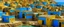 Placeholder: A blue village near a beach designed in ancient Egyptian hieroglyphics painted by Gustav Klimt