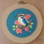 Placeholder: exquisite kingfisher in embroidery hoop, intricate, highly detailed, linen and wood backdrop