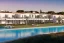 Placeholder: Sunset algarve in quinta do lago, a modern luxury villa apartments with 250 meters long and a pool on rooftop, with a separate clubhouse building facility with green roofs, overlooking the campus sport facility and inserted in the Ria Formosa Natural park, on a slope with pinus pinea, a wrap around low speed veicular road