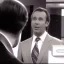 Placeholder: a man in a suit leaning forward to talk to someone, 80's television screengrab