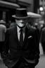Placeholder: A member from anonymous with the anonymous mask on and with a black fedora hat and a fine black and white suit standing, Anonymously.