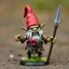 Placeholder: gnome troll miniature model half painted arms outstretched holding spear offering gift