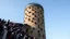 Placeholder: Cylindrical tower with lots of randomly placed windows, viewing platform on top, long queue of people waiting to go in, award-winning photograph, exquisite realism