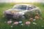 Placeholder: A car in the grass, transparent glass sasin, 3d render, 4k Flowers in the body.