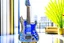 Placeholder: A lovely clear transparent resin guitar with forget-me-not design in a modern room in sunshine