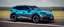 Placeholder: a military fighter jet station wagon hybrid designed by volkswagen only one vehicle per image painted metallic orange traveling at a high rate of speed, jet intake off of front center of vehicle and jet exhaust out the rear with bright blue flame