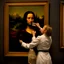 Placeholder: Mona Lisa comes out of the picture and kisses a young navy officer who is standing in the museum looking at her picture