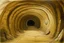 Placeholder: A beige underground tunnel with moles painted by Salvador Dali