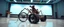Placeholder: in the style of Escher , pinhole cam, airbrush 3d rendering, on tv screen:A five-second cinematic single take in a clean industrial presentation hall. A bizarre mechanically plausible tracked atv machine stands beside a presentation podium, designed to look like a giant mechanical praying mantis. Two large bicycle wheels form its main body and four thin articulated mechanical legs support it. Two long folded mechanical front arms resemble mantis forelegs, huge head and arms