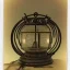 Placeholder: polaroid of fireflies inside a wrought iron bell jar, luminescent glow, moody, tender, photorealistic, curling steam and smoke