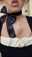 Placeholder: a girl wearing a black bow in her neck