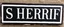 Placeholder: wide hand painted old sign that reads: "SHERRIF" white on black with inset boarder stripe in white
