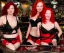 Placeholder: a photograph two red hair women in black and red lingerie on a bar