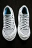 Placeholder: The bottom of the soles of two shoes. The tread pattern is white and made entirely from the shapes of ghosts. Use no more than 4 colours.