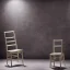 Placeholder: a chair on stage under spotlight