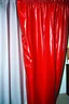 Placeholder: A shiny red latex on a curtain, worn kodachrome