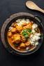 Placeholder: A snapchat realistic like image of cooked chicken curry with rice and vegetables served in a bowl. The bowl itself is matte black, giving a high-quality, elegant but minimalistic impression and has no handles. It sits on a black surface that has a texture similar to a slate slab without being visually overwhelming. The entire image has a very aesthetic appeal. The food should look delicious and photorealistic, with all ingredients clearly visible. A top down perspective.