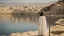 Placeholder: [the time of Jesus] close to the old town of Nazareth, a view on the Lake of Genesareth. a young woman in linen dress, she has her wooden rod she looks at the people down around the shore