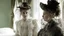 Placeholder: two Victorian older girls wearing elaborate lace cloaks