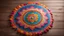 Placeholder: center view of a colorful Rangoli on a earthy rustic floor-surface with lots of diya surrounding the rangoli.