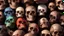 Placeholder: a picture of a dark, comedic, anatomically correct wall of colorful tightly packed stacked cyborg skulls of varying sizes and expressions, photo realistic, insanely meticulous, highly detailed, part of a collection of bones on display, 64k, dystopian, vray