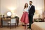 Placeholder: very beautiful lady with beautiful midi skirt and blouse standing next to her couple in a luxury bedroom with high heels next to makeup desk looking to camera