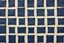 Placeholder: canvas background covered with a grid of many irregular rectangular weathered navy blue leather patches that are each stitched around the edges