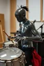 Placeholder: The whole body of Maniquí de glassy Artist mader playing the a hollow Drums , studio gears in the background