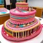 Placeholder: A giant pink cake filled with musical instruments designed in Navajo yarn