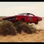 Placeholder: dramatic angle of dukes of hazard's general lee - 1969 red dodge charger with "01" on side jumping over a bush in a dusty field