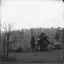 Placeholder: A landscape, odd black and white old photo, dystopic atmosphere, trees, some odd houses, George Grosz
