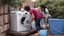 Placeholder: couple drains water from household washing machine