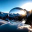 Placeholder: Frozen bubble in front of a snowy mountain landscape, the bubble has wonderful icecrystals and the sun is shining, frozen, cold outside, beautiful small ice flowers in front of the bubble