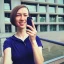 Placeholder: A short haired, female software engineer taking a selfie in front of Building 92 at Microsoft in Redmond, Washington