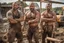 Placeholder: portrait shot photography of two ugly 36 year old beefy big robust burly italian carpenters embraced in the mud, dirty and wet, wearing bulging shorts, shirtless, hairy chest, serious, very virile, short beard, shaved hair,, , in a sunny construction work area, photorealistic , photorealistic