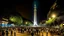 Placeholder: ciudad de buenos aires, es de noche, hay un montón de gente alrededor bailando y tomando, luces blancas y coloridas, se muestra el obelisco