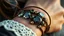 Placeholder: very close-up macro photo of a bracelet made of brown leather and gemms on a woman's wrist, detailed, sharp contrasts, realistic, cinematic, blur background