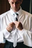 Placeholder: man dressed in church dress clothes opening his shirt to reveal a white t-shirt