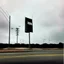 Placeholder: Minimal contemporary abstract oil paintings of desolate 1960s carpark with road markings and concrete fragments. Overlay with grungy typography graphics. style of Justin Mortimer and Francis Bacon.