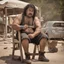 Placeholder: photography of a marocan ugly burly serious wet sweaty, chubby strong fat hairy carpenter, shirtless, short pants, bulge, manly chest, mustache and short beard, 36 years old, long hair, sitting with open legs on a chair , on a construction site, in the middle of a road, under the August sun, angry eyes, , hyper-realistic, photorealistic , frontal view from the ground